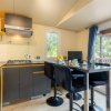 Cucina moderna con bancone e sgabelli neri.