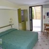 Camera d'albergo con letto matrimoniale, scrivania e porta finestra.